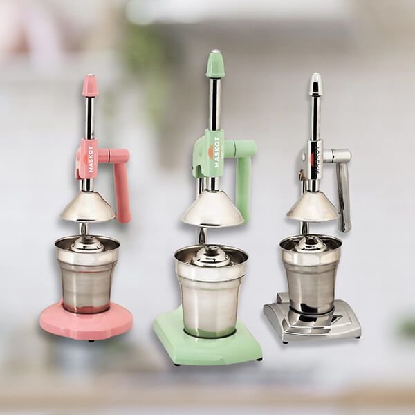 Pink, green and chrome household fruit presses